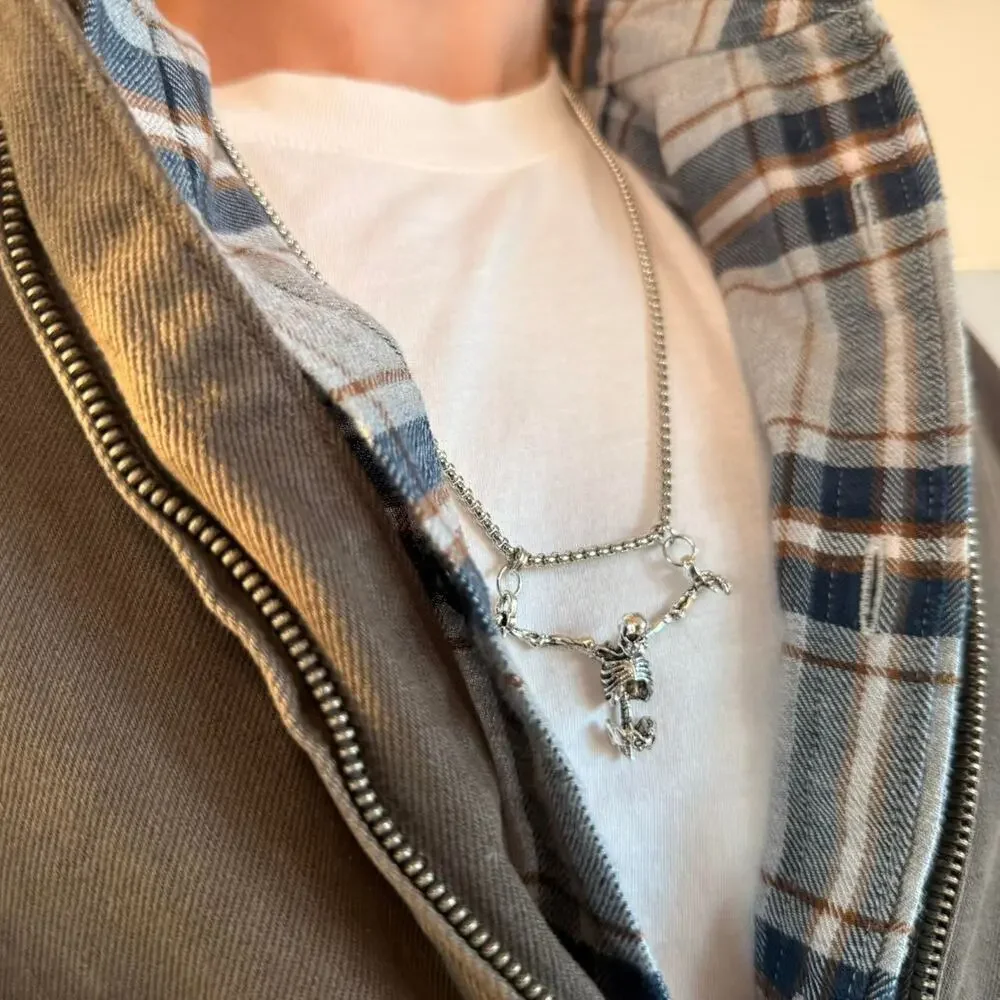 Unisex silver skeleton necklace featuring a bold, grunge-inspired design